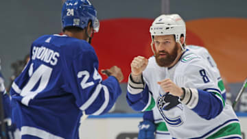TORONTO, ON - FEBRUARY 4: Jordie Benn #8 of the Vancouver Canucks and Wayne Simmonds #24 of the Toronto Maple Leafs get set to trade punches during an NHL game at Scotiabank Arena on February 4, 2021 in Toronto, Ontario, Canada. The Maple Leafs defeated the Canucks 7-3.(Photo by Claus Andersen/Getty Images)
