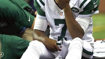 Aug 9, 2013; Detroit, MI, USA; New York Jets quarterback Geno Smith (7) his is ankle examined after limping off the field in the third quarter of a preseason game against the Detroit Lions at Ford Field. Mandatory Credit: Andrew Weber-USA TODAY Sports