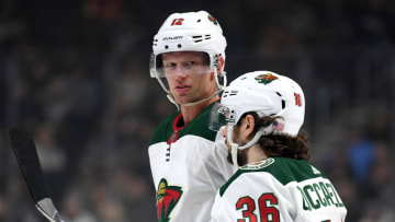 LOS ANGELES, CALIFORNIA - NOVEMBER 12: Eric Staal #12 of the Minnesota Wild speaks with Mats Zuccarello #36 during a 3-1 loss to the Los Angeles Kings at Staples Center on November 12, 2019 in Los Angeles, California. (Photo by Harry How/Getty Images)