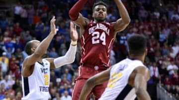 Mar 11, 2016; Kansas City, MO, USA; Oklahoma Sooners guard Buddy Hield (24) passes the ball as West Virginia Mountaineers guard Tarik Phillip (12) defends in the second half during the Big 12 Conference tournament at Sprint Center. West Virginia won 69-67. Mandatory Credit: Denny Medley-USA TODAY Sports