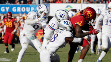 Wide receiver La'Michael Pettway #7 of the Iowa State Cyclones is tackled by Kansas football players. (Photo by David Purdy/Getty Images)