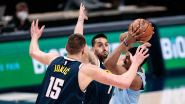 Apr 19, 2021; Denver, Colorado, USA; Memphis Grizzlies guard De'Anthony Melton (0) looks to pass the ball under pressure from Denver Nuggets center Nikola Jokic (15) and guard Facundo Campazzo (7) in the first quarter at Ball Arena. Mandatory Credit: Isaiah J. Downing-USA TODAY Sports