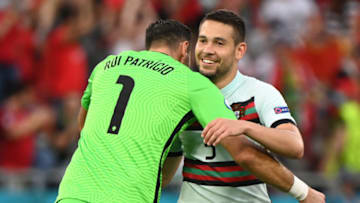 Raphael Guerreiro celebrates Portugal's win (Photo by ATTILA KISBENEDEK/POOL/AFP via Getty Images)