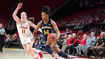 COLLEGE PARK, MD - DECEMBER 28: Akienreh Johnson #14 of the Michigan Wolverines dribbles by Taylor Mikesell #11 of the Maryland Terrapins during a women's college basketball game at the Xfinity Center on December 28, 2019 in College Park, Maryland. (Photo by Mitchell Layton/Getty Images)