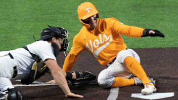 Tennessee center fielder Drew Gilbert (1) slides into home plate pat Vanderbilt catcher Jack Bulger (16) to score a run during the first inning at Hawkins Field Saturday, April 2, 2022 in Nashville, Tenn.Nas Vandy Ut 008
