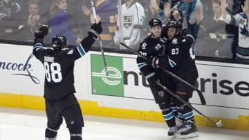 May 18, 2013; San Jose, CA, USA; San Jose Sharks center Logan Couture (39) is congratulated by defenseman Brent Burns (88) and center Scott Gomez (23) after scoring the game-winning goal against the Los Angeles Kings in overtime of game three of the second round of the 2013 Stanley Cup Playoffs at HP Pavilion. The San Jose Sharks defeated the Los Angeles Kings 2-1 in overtime. Mandatory Credit: Ed Szczepanski-USA TODAY Sports