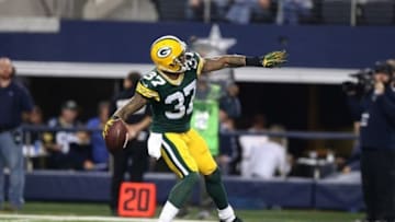 Dec 15, 2013; Arlington, TX, USA; Green Bay Packers cornerback Sam Shields (37) throws the ball into the stands after an interception in the fourth quarter against Dallas Cowboys receiver Miles Austin (19) at AT
