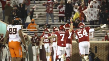Nov 21, 2020; Norman, Oklahoma, USA; Oklahoma Sooners quarterback Spencer Rattler (7) reacts after throwing a touchdown pass during the second half against the Oklahoma State Cowboys at Gaylord Family-Oklahoma Memorial Stadium. Mandatory Credit: Kevin Jairaj-USA TODAY Sports