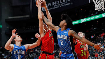 ATLANTA, GA - DECEMBER 09: Ersan Ilyasova #7 of the Atlanta Hawks grabs a rebound against Mario Hezonja #8 and Elfrid Payton #2 of the Orlando Magic at Philips Arena on December 9, 2017 in Atlanta, Georgia. NOTE TO USER: User expressly acknowledges and agrees that, by downloading and or using this photograph, User is consenting to the terms and conditions of the Getty Images License Agreement. (Photo by Kevin C. Cox/Getty Images)