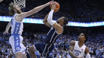 CHAPEL HILL, NORTH CAROLINA - FEBRUARY 05: Wendell Moore Jr. #0 of the Duke Blue Devils drives between Brady Manek #45 and Caleb Love #2 of the North Carolina Tar Heels during the first half of their game at the Dean E. Smith Center on February 05, 2022 in Chapel Hill, North Carolina. (Photo by Grant Halverson/Getty Images)