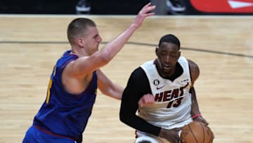 Jun 7, 2023; Miami, Florida, USA; Miami Heat center Bam Adebayo (13) dribbles the ball against Denver Nuggets center Nikola Jokic (15) during the fourth quarter in game three of the 2023 NBA Finals at Kaseya Center. Mandatory Credit: Jim Rassol-USA TODAY Sports