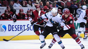 Mar 17, 2016; Glendale, AZ, USA; Arizona Coyotes center Boyd Gordon (15) and San Jose Sharks center Nick Spaling (16) battle for the puck during the third period at Gila River Arena. Mandatory Credit: Matt Kartozian-USA TODAY Sports