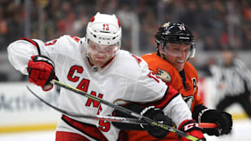 ANAHEIM, CALIFORNIA - OCTOBER 18: Warren Foegele #13 of the Carolina Hurricanes battles Jakob Silfverberg #33 of the Anaheim Ducks (Photo by Sean M. Haffey/Getty Images)