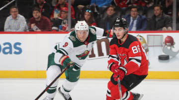 NEWARK, NEW JERSEY - NOVEMBER 26: Jack Hughes #86 of the New Jersey Devils skates against Mikko Koivu #9 of the Minnesota Wild at the Prudential Center on November 26, 2019 in Newark, New Jersey. (Photo by Bruce Bennett/Getty Images)