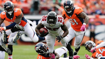 Oct 9, 2016; Denver, CO, USA; Atlanta Falcons running back Tevin Coleman (26) is tackled by Denver Broncos cornerback Aqib Talib (21) in the first quarter at Sports Authority Field at Mile High. Mandatory Credit: Isaiah J. Downing-USA TODAY Sports