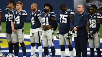 INGLEWOOD, CA - SEPTEMBER 13: From left to right, Trysten Hill #72, quarterbacks Andy Dalton #14 and Dak Prescott #4, running back Ezekiel Elliott #21, Cameron Erving #75, head coach Mike McCarthy and CeeDee Lamb #88, Michael Gallup #13, and Donovan Wilson #37 of the Dallas Cowboys stand during a ceremony after warm ups before the start of the football game against Los Angeles Rams at SoFi Stadium on September 13, 2020 in Inglewood, California. (Photo by Kevork Djansezian/Getty Images)