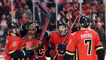 CALGARY, AB - DECEMBER 06: Calgary Flames Goalie Mike Smith (41) celebrates his team's 2-0 win over the Minnesota Wild with Defenceman Mark Giordano (5), Defenceman Travis Hamonic (24) and Defenceman T.J. Brodie (7) after an NHL game where the Calgary Flames hosted the Minnesota Wild on December 6, 2018, at the Scotiabank Saddledome in Calgary, AB. (Photo by Brett Holmes/Icon Sportswire via Getty Images)