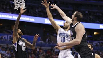 Nov 21, 2015; Orlando, FL, USA; Orlando Magic forward Evan Fournier (10) shoots between Sacramento Kings center Willie Cauley-Stein (00) and center Kosta Koufos (41) during the second half of a basketball game at Amway Center. Sacramento won 97-91. Mandatory Credit: Reinhold Matay-USA TODAY Sports
