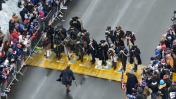 Feb 4, 2015; Boston, MA, USA; The New England Patriots End Zone Militia has a moment of silence at the Boston Marathon finish line during the Super Bowl XLIX rolling rally parade. Mandatory Credit: Brian Fluharty-USA TODAY Sports