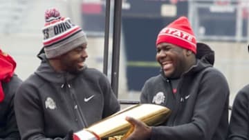 Jan 24, 2015; Columbus, OH, USA; Ohio State Buckeyes quarterback J.T. Barrett (16) hands the National Championship trophy to quarterback Cardale Jones (12) during the National Championship celebration at Ohio Stadium. Mandatory Credit: Greg Bartram-USA TODAY Sports
