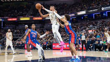 Indiana Pacers guard Tyrese Haliburton (0) passes the ball while Detroit Pistons guard Cade Cunningham (2) defends Credit: Trevor Ruszkowski-USA TODAY Sports