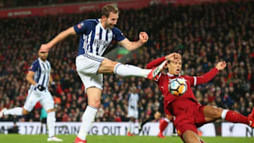 LIVERPOOL, ENGLAND - JANUARY 27: Craig Dawson of West Bromwich Albion takes a shot past Virgil van Dijk of Liverpool in the build up to an own goal scored by Joel Matip of Liverpool during The Emirates FA Cup Fourth Round match between Liverpool and West Bromwich Albion at Anfield on January 27, 2018 in Liverpool, England. (Photo by Alex Livesey/Getty Images)