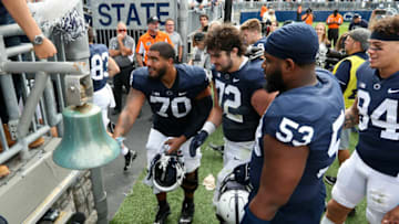 Sep 25, 2021; University Park, Pennsylvania, USA; Penn State Nittany Lions offensive linesman Juice Scruggs (70) rings the victory bell following the completion of the game against the Villanova Wildcats at Beaver Stadium. Penn State defeated Villanova 38-17. Mandatory Credit: Matthew OHaren-USA TODAY Sports