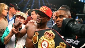 May 3, 2014; Las Vegas, NV, USA; Floyd Mayweather Jr. celebrates with the championship belt after defeating Marcos Maidana (not pictured) during their fight at the MGM Grand. Mandatory Credit: Mark J. Rebilas-USA TODAY Sports