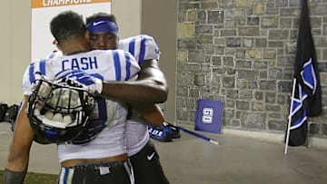Oct 24, 2015; Blacksburg, VA, USA; Duke Blue Devils defensive tackle Carlos Wray (98) and Blue Devils safety Jeremy Cash (16) celebrate after their game against the Virginia Tech Hokies at Lane Stadium. The Blue Devils won 45-43 in quadruple overtime. Mandatory Credit: Geoff Burke-USA TODAY Sports