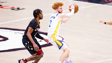 CLEVELAND, OH - APRIL 15: Nico Mannion #2 of the Golden State Warriors handles the ball against Darius Garland #10 of the Cleveland Cavaliers during the fourth quarter at Rocket Mortgage Fieldhouse on April 15, 2021 in Cleveland, Ohio. NOTE TO USER: User expressly acknowledges and agrees that, by downloading and or using this photograph, User is consenting to the terms and conditions of the Getty Images License Agreement. (Photo by Lauren Bacho/Getty Images)