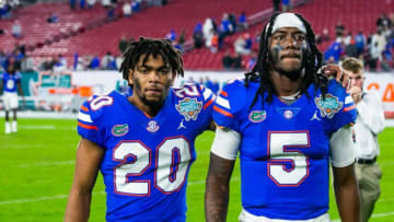 Florida Gators running back Malik Davis (20) and Florida Gators quarterback Emory Jones (5) walk of the field after the UCF Knights defeats the Florida Gators, 29-17 in the Gasparilla Bowl Thursday, December 23, 2021, at Raymond James Stadium in Tampa, FL. [Doug Engle/Ocala Star-Banner]2021Oca 122324 Ufvsucfgasbowl