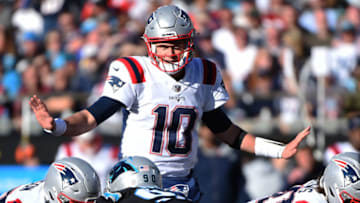 CHARLOTTE, NORTH CAROLINA - NOVEMBER 07: Mac Jones #10 of the New England Patriots calls a play at the line during the third quarter against the Carolina Panthers at Bank of America Stadium on November 07, 2021 in Charlotte, North Carolina. (Photo by Lance King/Getty Images)
