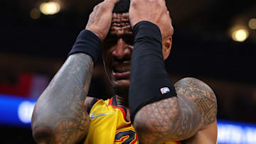ATLANTA, GEORGIA - JANUARY 17: John Collins #20 of the Atlanta Hawks reacts after losing the ball against the Milwaukee Bucks during the first half at State Farm Arena on January 17, 2022 in Atlanta, Georgia. NOTE TO USER: User expressly acknowledges and agrees that, by downloading and or using this photograph, User is consenting to the terms and conditions of the Getty Images License Agreement. (Photo by Kevin C. Cox/Getty Images)