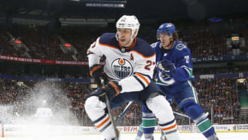 VANCOUVER, BC - OCTOBER 7: Loui Eriksson #21 of the Vancouver Canucks and Milan Lucic #27 of the Edmonton Oilers skate up ice during their NHL game at Rogers Arena October 7, 2017 in Vancouver, British Columbia, Canada. Vancouver won 3-2. (Photo by Jeff Vinnick/NHLI via Getty Images)"n