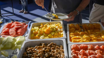 FUNCHAL, PORTUGAL - JUNE 26: Guests help themselves at the breakfast buffet at one of the restaurants in five-star Pestana Casino Park hotel on June 26, 2019 in Funchal, Portugal. The hotel, designed by Brazilian architect Óscar Niemeyer, is located next to the cruise harbor of the Bay of Funchal and it is one of the most famous hotels on the island, with direct access to the Casino. Madeira Island is one of Europe's most sought after tourist locations where travelers can be counted by the thousands all year round. The region offers summer weather and it is one of the safest holiday destinations in the world. (Photo by Horacio Villalobos#Corbis/Corbis via Getty Images)