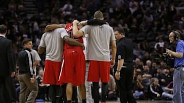 Mar 12, 2014; San Antonio, TX, USA; Portland Trail Blazers forward LaMarcus Aldridge (12) is helped off the court after an injury during the second half at AT&T Center. Mandatory Credit: Soobum Im-USA TODAY Sports