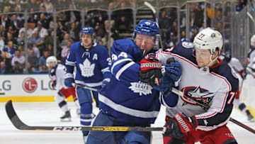 Josh Anderson of the Columbus Blue Jackets battles against Morgan Rielly of the Toronto Maple Leafs. (Photo by Claus Andersen/Getty Images)