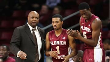 Mar 4, 2014; Chestnut Hill, MA, USA; Florida State Seminoles head coach Leonard Hamilton (left) speaks to guard Devon Bookert (1) during the second half of a game against the Boston College Eagles at Silvio O. Conte Forum. Mandatory Credit: Mark L. Baer-USA TODAY Sports