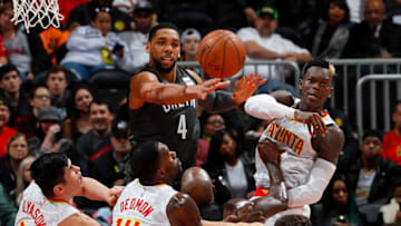 ATLANTA, GA - JANUARY 12: Jahlil Okafor #4 of the Brooklyn Nets and Dennis Schroder #17 of the Atlanta Hawks knock away a rebound over Milton Doyle #14, Ersan Ilyasova #7 and Dewayne Dedmon #14 at Philips Arena on January 12, 2018 in Atlanta, Georgia. NOTE TO USER: User expressly acknowledges and agrees that, by downloading and or using this photograph, User is consenting to the terms and conditions of the Getty Images License Agreement. (Photo by Kevin C. Cox/Getty Images)
