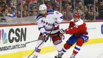 Mar 4, 2016; Washington, DC, USA; New York Rangers defenseman Kevin Klein (8) skates with the puck as Washington Capitals right wing Daniel Winnik (26) defends in the third period at Verizon Center. The Rangers won 3-2. Mandatory Credit: Geoff Burke-USA TODAY Sports