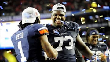 Dec 7, 2013; Atlanta, GA, USA; Auburn Tigers wide receiver Trovon Reed (1) and Auburn Tigers offensive linesman Greg Robinson (73) celebrate after the 2013 SEC Championship game against the Missouri Tigers at Georgia Dome. The Auburn Tigers defeated the Missouri Tigers 59-42. Mandatory Credit: Kevin Liles-USA TODAY Sports