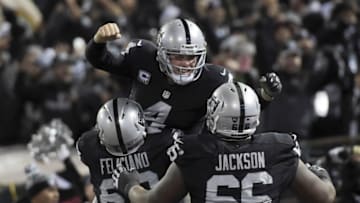 Dec 24, 2015; Oakland, CA, USA; Oakland Raiders quarterback Derek Carr (4) celebrates with offensive guard Jon Feliciano (68) and guard Gabe Jackson (66) after a touchdown in the fourth quarter against the San Diego Chargers during an NFL football game at O.co Coliseum. The Raiders defeated the Chargers 23-20 in overtime. Mandatory Credit: Kirby Lee-USA TODAY Sports