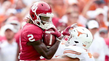 DALLAS, TX - OCTOBER 06: CeeDee Lamb #2 of the Oklahoma Sooners carries the ball against Caden Sterns #7 of the Texas Longhorns in the first half of the 2018 AT&T Red River Showdown at Cotton Bowl on October 6, 2018 in Dallas, Texas. (Photo by Tom Pennington/Getty Images)