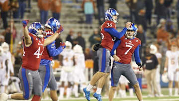 Nov 19, 2016; Lawrence, KS, USA; Kansas Jayhawks place kicker Matthew Wyman kicks the game tying field goal against the Texas Longhorns and celebrates with teammates at Memorial Stadium. Mandatory Credit: Gary Rohman-USA TODAY Sports