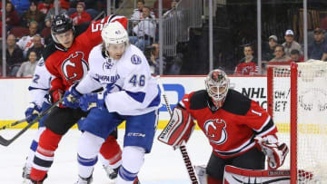 Apr 7, 2016; Newark, NJ, USA; New Jersey Devils goalie Keith Kinkaid (1) watches the pack behind Tampa Bay Lightning right wing Michael Blunden (46) and Devils defenseman Vojtech Mozik (53) during the third period at Prudential Center. The Lightning won 4-2. Mandatory Credit: Ed Mulholland-USA TODAY Sports