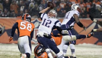 Nov 29, 2015; Denver, CO, USA; New England Patriots quarterback Tom Brady (12) is sacked by Denver Broncos linebacker Shane Ray (56) in the fourth quarter at Sports Authority Field at Mile High. The Broncos defeated the Patriots 30-24 in overtime. Mandatory Credit: Ron Chenoy-USA TODAY Sports