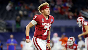 Dec 30, 2020; Arlington, TX, USA; Oklahoma Sooners quarterback Spencer Rattler (7) reacts after throwing a touchdown pass during the first half against the Florida Gators at AT&T Stadium. Mandatory Credit: Kevin Jairaj-USA TODAY Sports