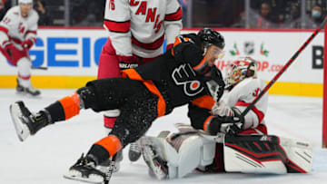 Nov 26, 2021; Philadelphia, Pennsylvania, USA; Philadelphia Flyers right wing Travis Konecny (11) falls to the ice against the Carolina Hurricanes in the third period at the Wells Fargo Center. Mandatory Credit: Mitchell Leff-USA TODAY Sports