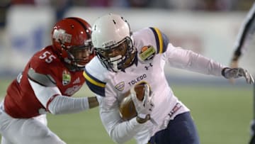 Jan 4, 2015; Mobile, AL, USA; Toledo Rockets wide receiver Alonzo Russell (9) is pushed out of bounds by Arkansas State Red Wolves linebacker Xavier Woodson (55) after a pass reception in the second quarter of the 2015 GoDaddy Bowl at Ladd-Peebles Stadium. Mandatory Credit: Glenn Andrews-USA TODAY Sports