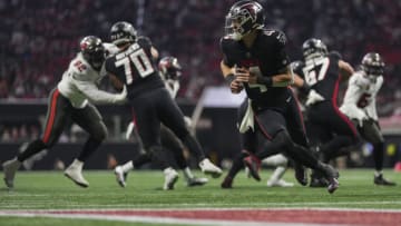 ATLANTA, GA - JANUARY 08: Desmond Ridder #4 of the Atlanta Falcons rolls out after handing the ball off against the Tampa Bay Buccaneers at Mercedes-Benz Stadium on January 8, 2023 in Atlanta, Georgia. (Photo by Cooper Neill/Getty Images)